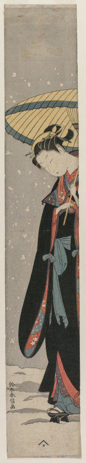 Young Woman Walking in Snow with Umbrella