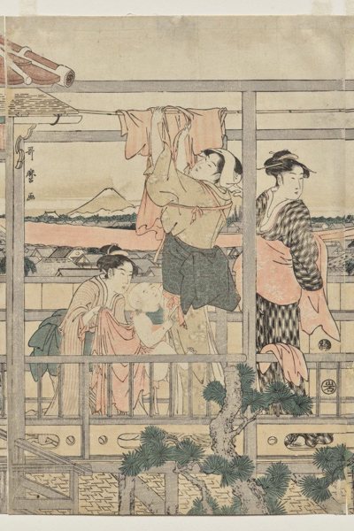 Women Hanging Laundry to Dry on a Balcony